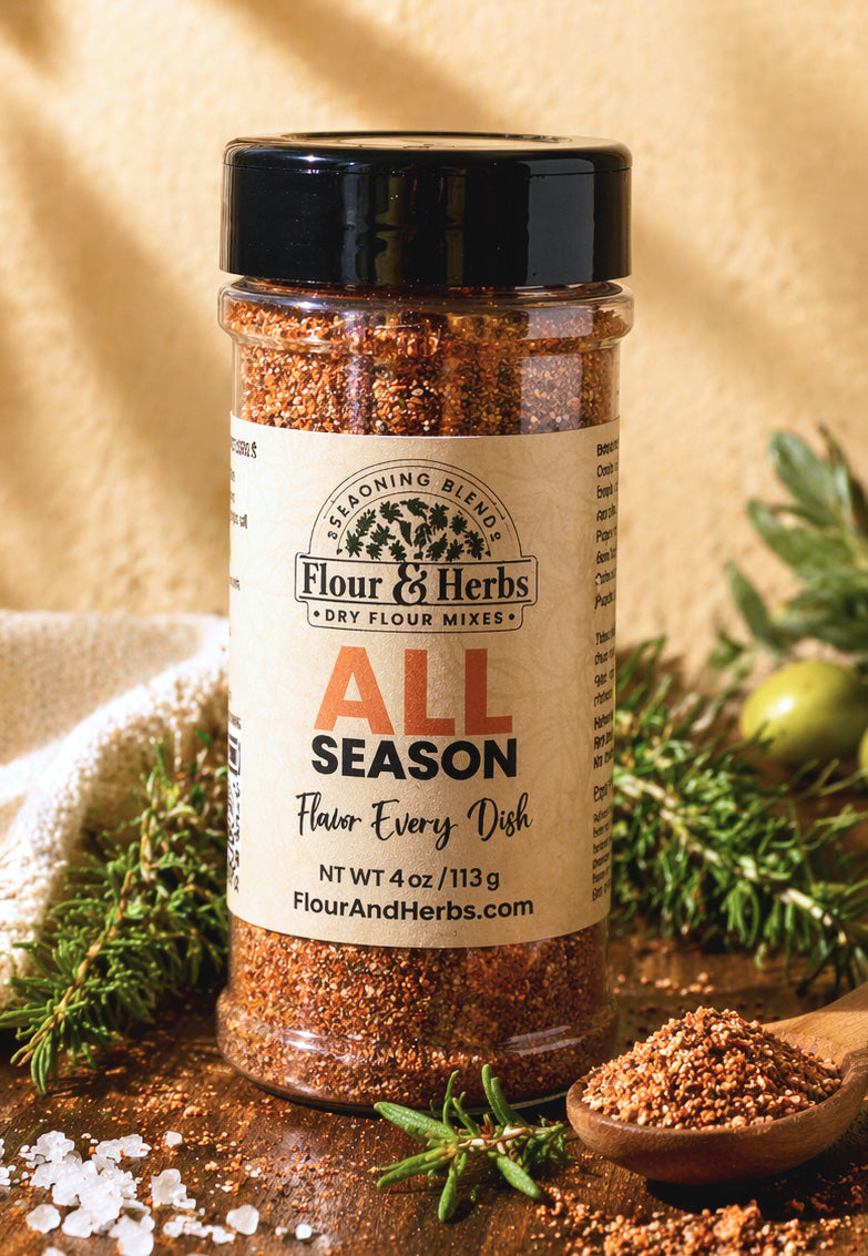 Flour & Herbs All Season artisan seasoning blend in a glass jar, surrounded by fresh herbs and spices on a dark rustic surface